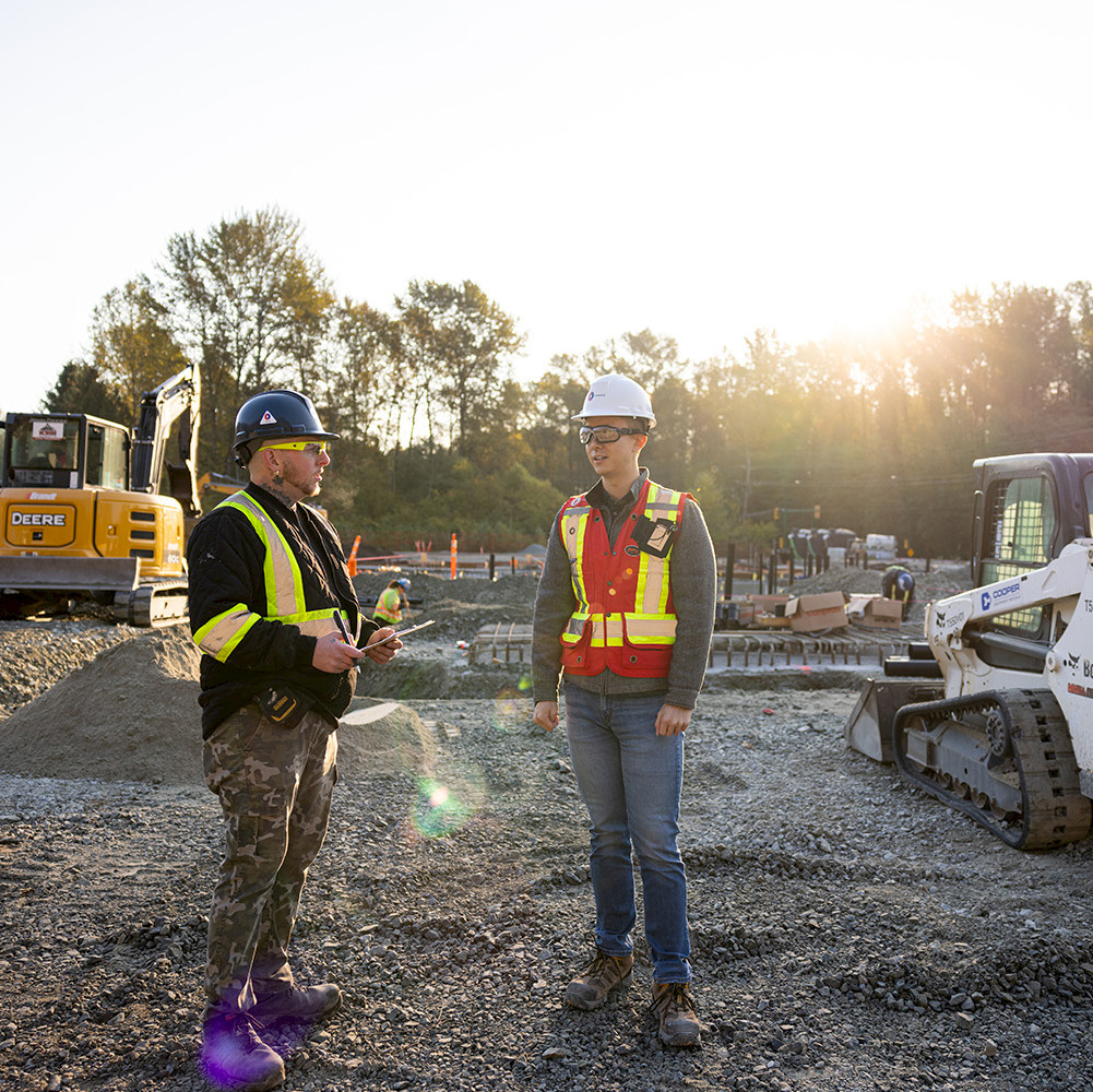 A female construction worker on site filling out a safety form