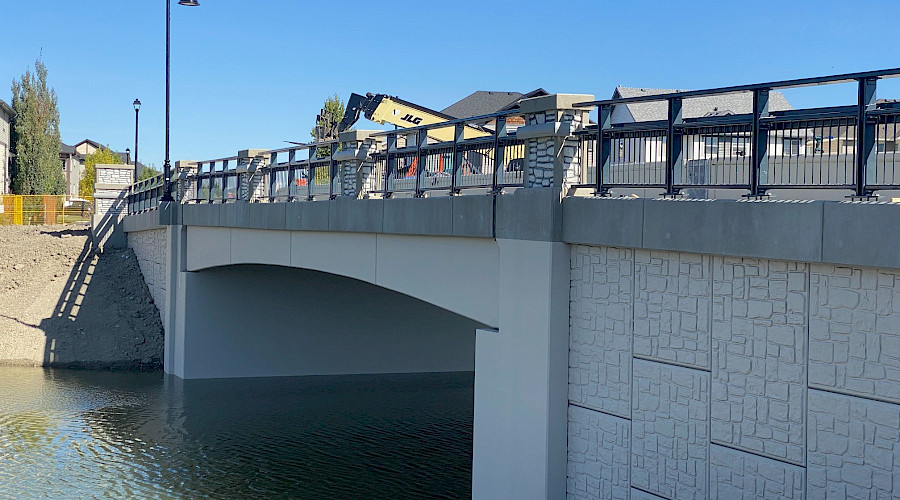 Image of the completed canal bridge with water running underneath, built by Chandos Construction Civil team.