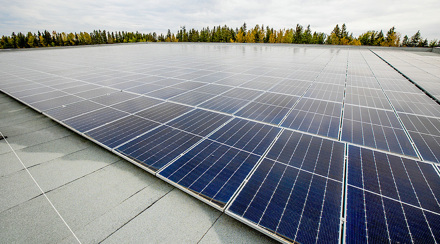 Exterior image of the  Ricochet Oil Corp Aquatic Centre built by Chandos Construciton featuring the solar panels