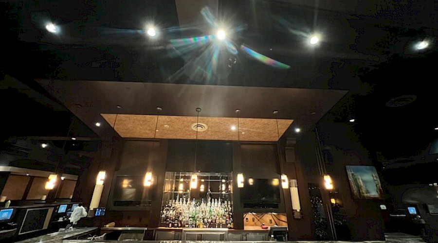 New updated lighting fixtures and marble counter tops at the bar at the Keg built by Chandos Construciton