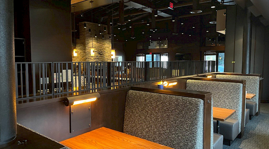 New reupholstered dining booths and the back of the new refurbished bar at Keg locations nationwide.
