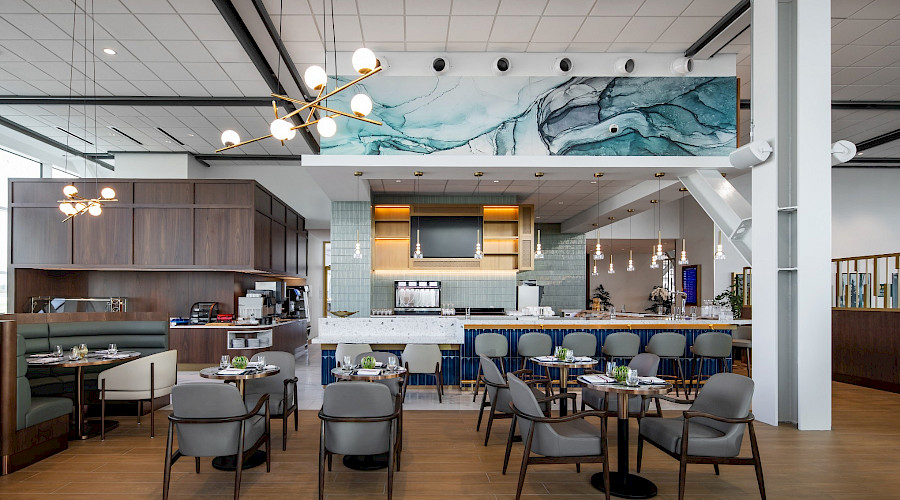 Interior image of the new Plaza Premium Lounge in YVR built by Chandos Construction Vancouver. Photo showcases one of the dining rooms, bars, and self serve buffets