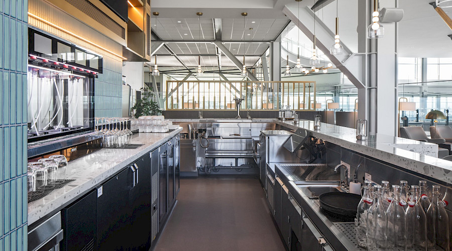 Interior image of the new Plaza Premium Lounge in YVR built by Chandos Construction Vancouver. Image showcases the back of the lounge bar.